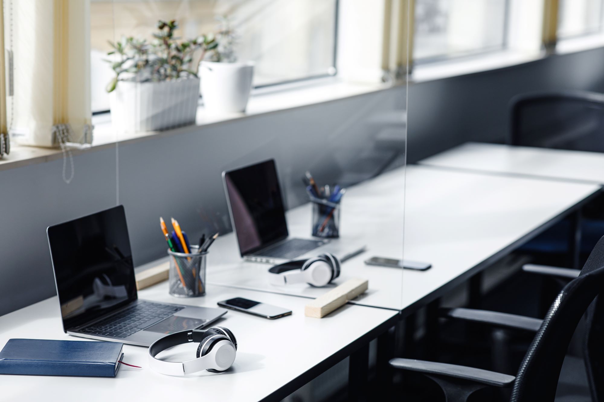 A couple of desks in an office managed by desk booking software